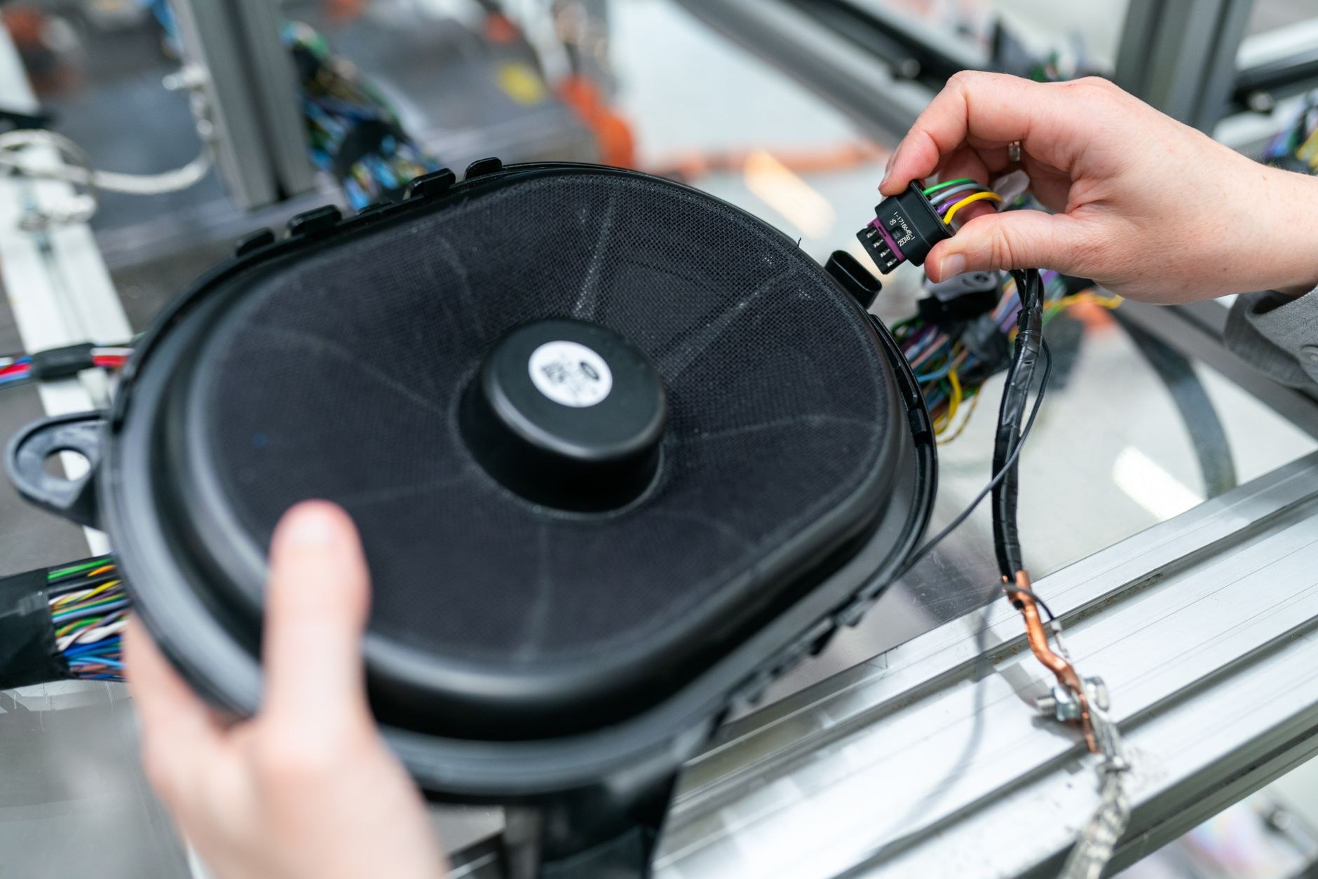 Speaker and wiring loom being connected on a bench