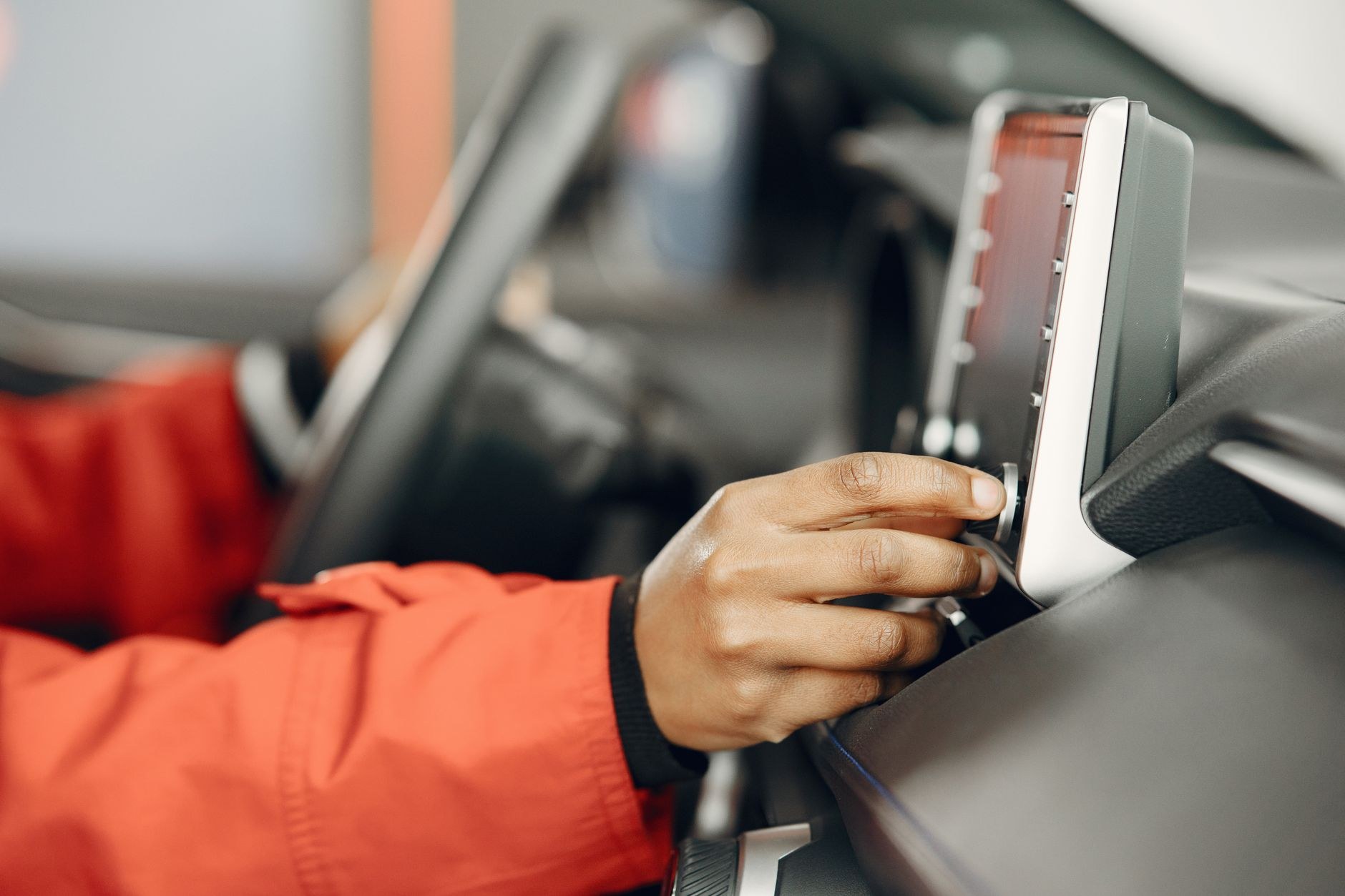 Hand adjusting an in dash screen inside a vehicle