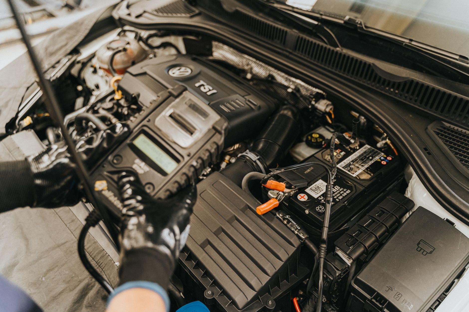 Engine bay open with the battery exposed during a charging system test