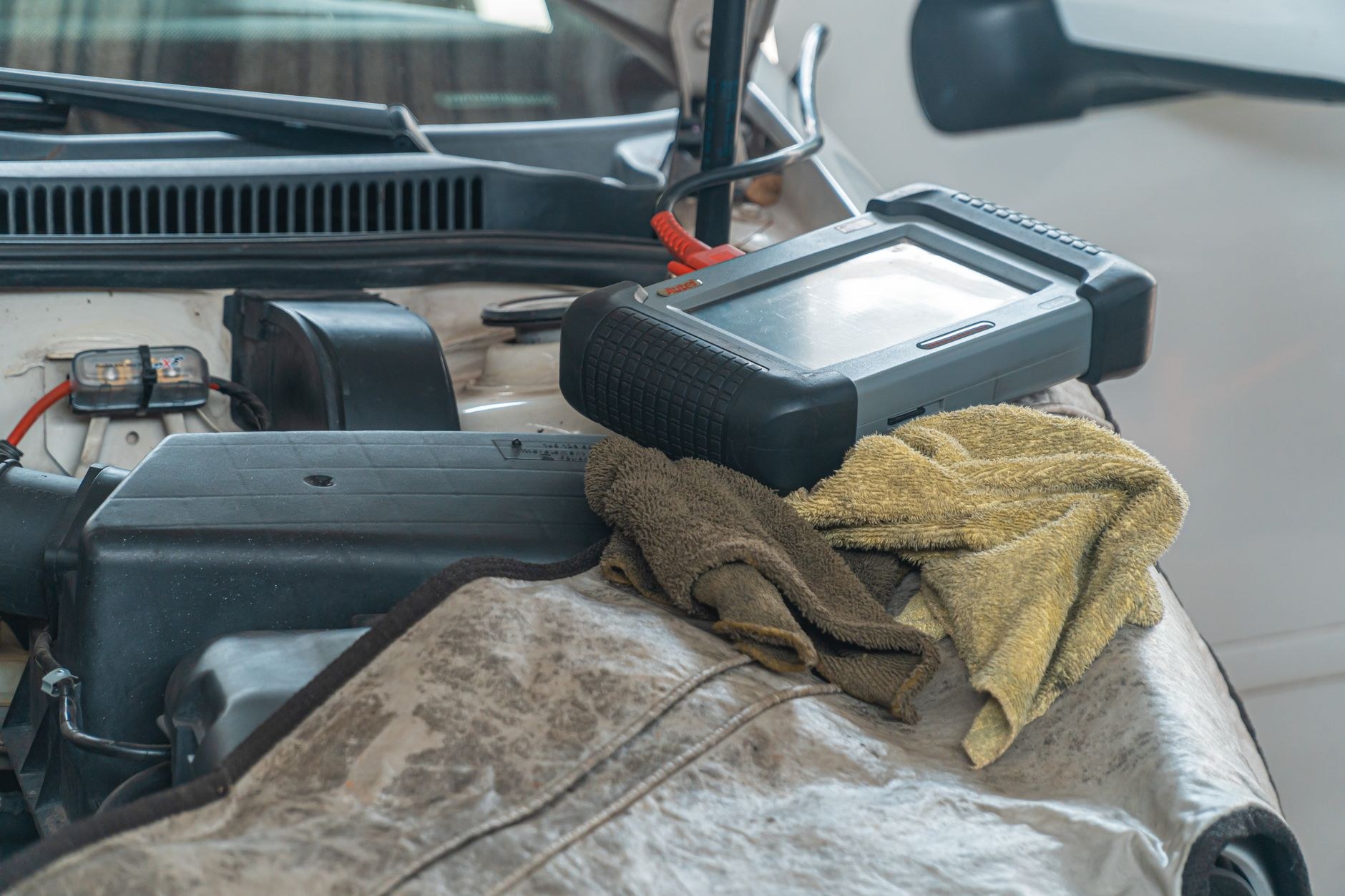 Diagnostic tablet resting on a fender cover while live data is read
